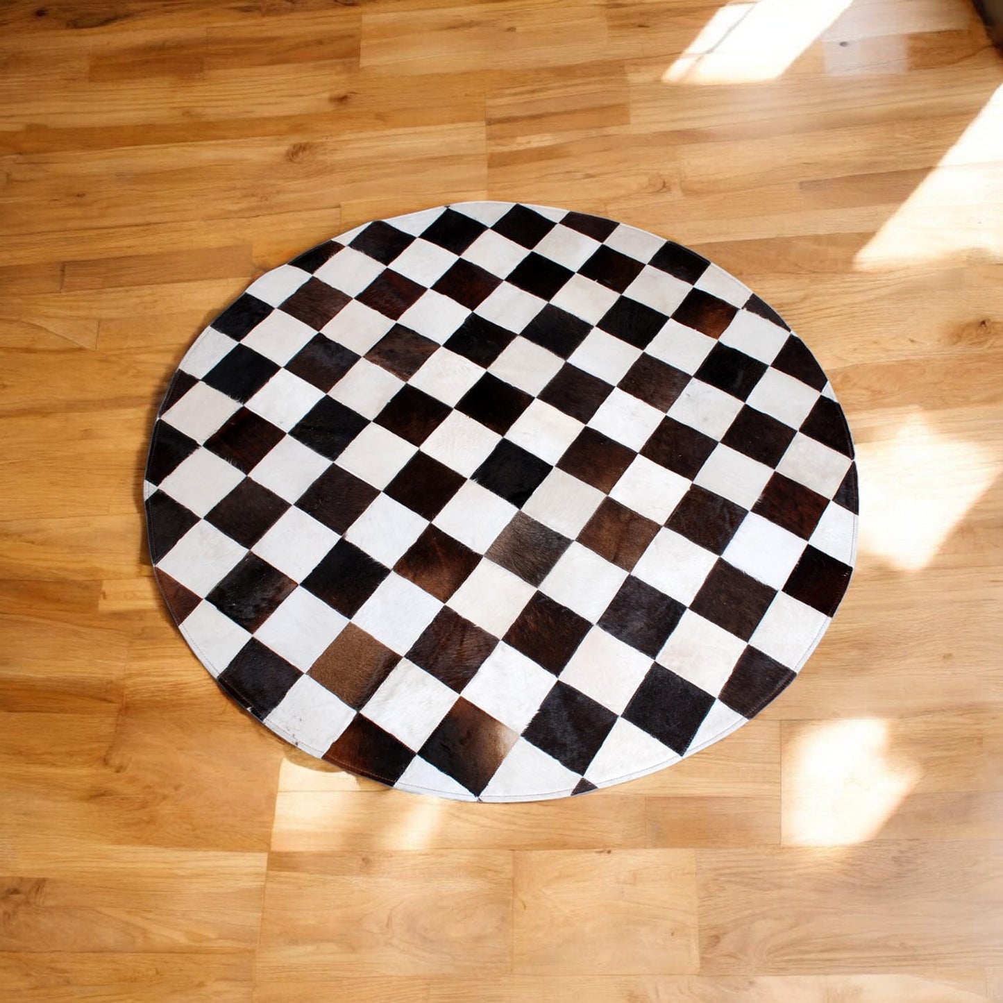 Handcrafted Round Cowhide Patchwork Rug – Black & White Checkered Design