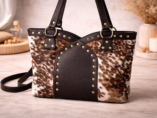 Handbag with cowhide pattern and studded details.